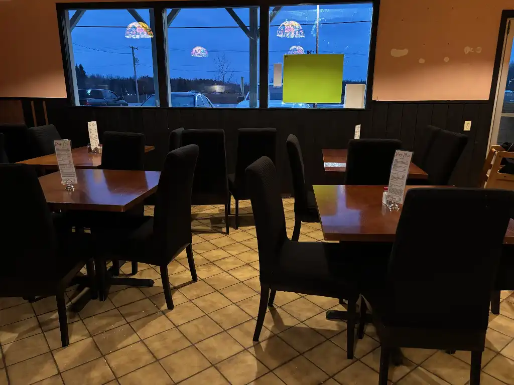 Restaurant interior — warm lighting, timber chairs and tables